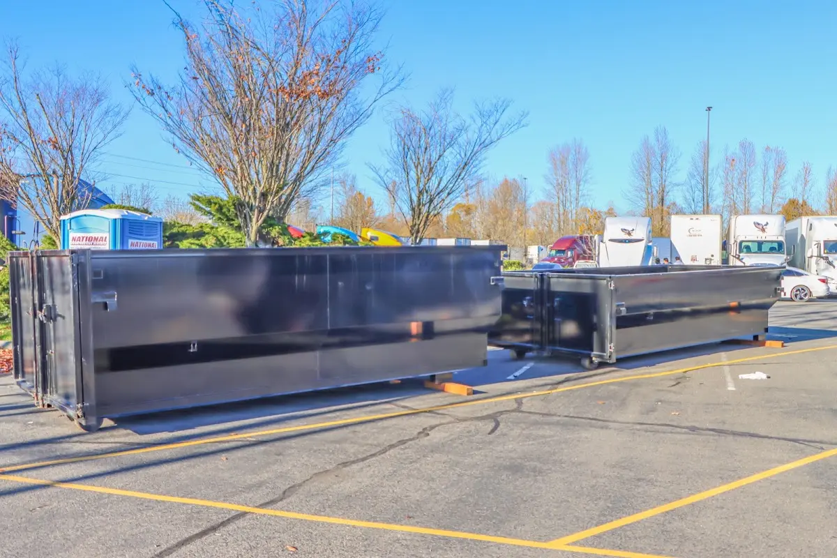 Professional dumpster rental service with roll-off container on residential driveway in Macon